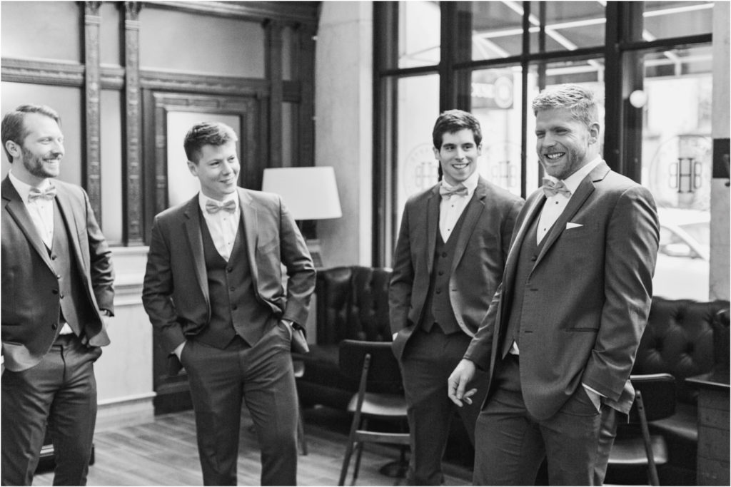 groom and groomsmen get ready before wedding