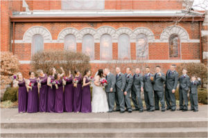 large wedding party in purple and gray